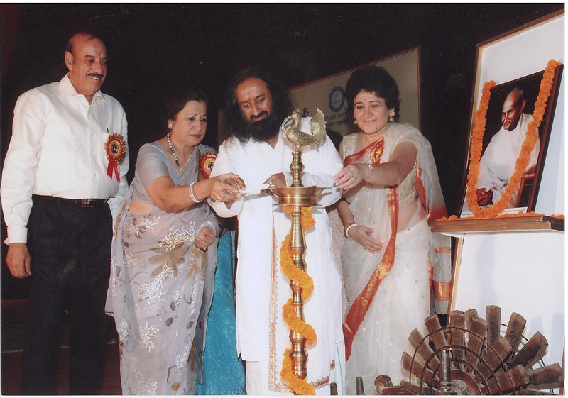 Mrs Ratan Kaul lightning the lamp with Sri Sri Ravishankar, Mrs Kusum Ansal and Mr Sushil Ansal